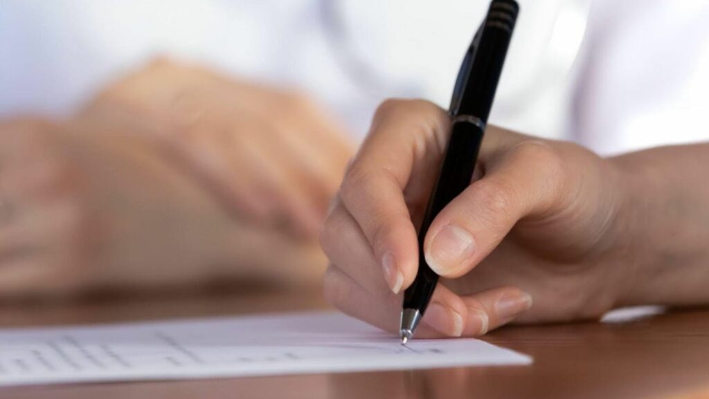 A close-up photo of a therapist is signing an emotional support animal (ESA) letter.